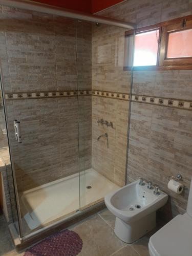 a bathroom with a shower and a toilet and a sink at Cielo Andino Colonial in Purmamarca