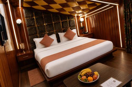 a bedroom with a bed and a bowl of fruit on a table at Pine view in Gulmarg