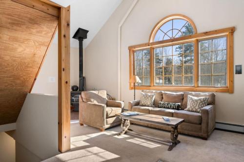 a living room with a couch and a table at Sugarbush Seclusion in Vermont in Waitsfield