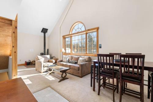 a living room with a table and a couch at Sugarbush Seclusion in Vermont in Waitsfield