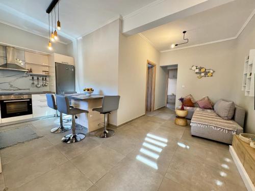 a kitchen and living room with a table and a couch at Averto House Lefkada in Lefkada