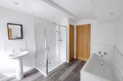 a white bathroom with a shower and a sink at Swallows Rest Cottage - 3 Bedrooms - Nr Looe in Looe