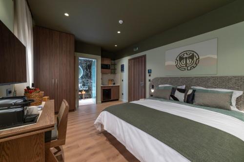 a bedroom with a large bed and a sink at Minotaur's Rest - Luxury Residences with Free Private Parking, near Port & Airport in Heraklio