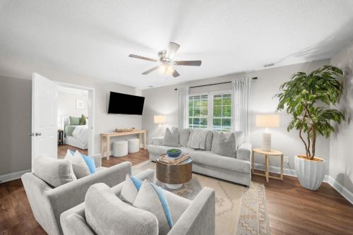 a living room with couches and a ceiling fan at GSU Getaway 4BR3BA spacious pet friendly in Statesboro