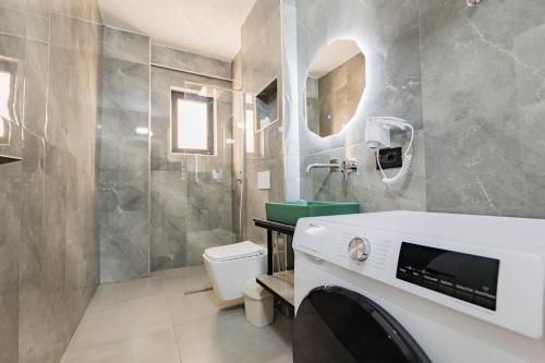 a bathroom with a toilet and a sink at Day Lux Superior Apartments in Sarandë