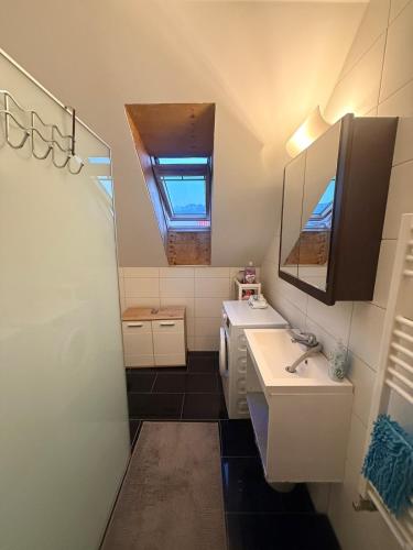 a small bathroom with a sink and a mirror at GalerieLoft Winterzeit Thunersee&Mountainview in Thun