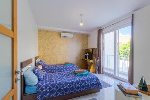 a bedroom with a bed and a large window at New Spacious Apartment 3 Bdr 2 Bth Bugibba 124 with View in St. Paul's Bay