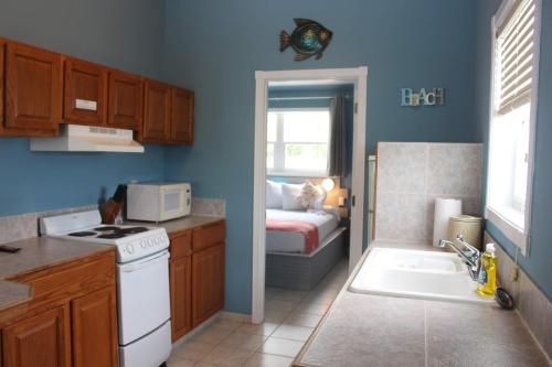 a kitchen with a sink and a stove top oven at Hideaways Exuma in Georgetown