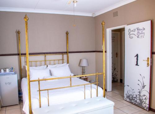 a bedroom with a bed with a yellow frame at Guesthouse Gabby in Klerksdorp