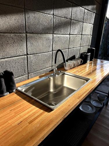 a kitchen counter with a stainless steel sink at Pedre Loft in La Pedrera