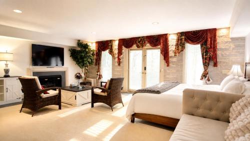 a bedroom with a king sized bed and a fireplace at Zen House in Princeton