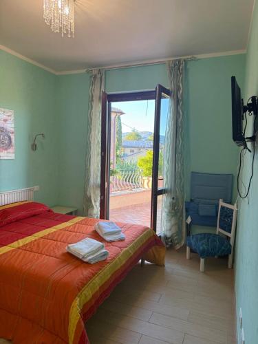 a bedroom with a bed and a sliding glass door at I Due Melograni Agriresort in Tarano