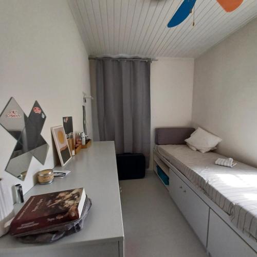 a small room with a bed and a desk at The Arch House in Kymi