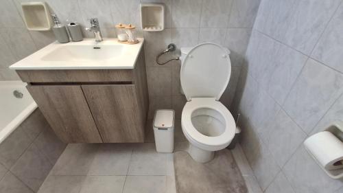 a bathroom with a toilet and a sink at Saint George Terrace House in Chios