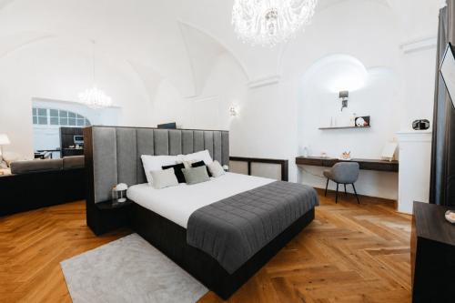 a bedroom with a bed and a living room at Contessa Apartments in Košice