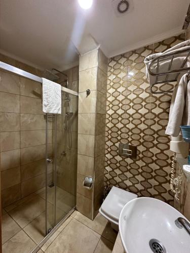 a bathroom with a shower and a toilet and a sink at Ethnica Hotel Old City in Istanbul