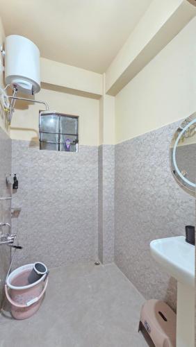 a bathroom with a sink and a toilet at Celeste Inn in Shillong