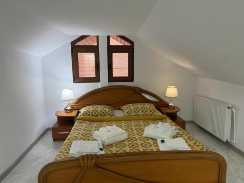 a bedroom with a bed with two towels on it at Vila Dari in Tulcea