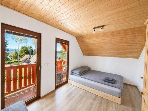 a small bedroom with a bed and a window at Kovarov26 in Frymburk