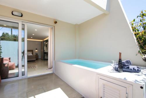 a bathtub in the corner of a room at Spitaki Pool House & Spitaki Jacuzzi Deluxe Suite in Corfu