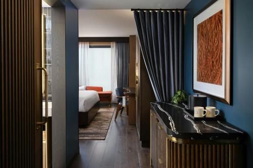 a hotel room with a bed and a desk at Hotel Trinity, Autograph Collection in Austin