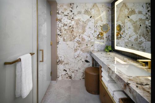 a bathroom with a sink and a mirror at Hotel Trinity, Autograph Collection in Austin
