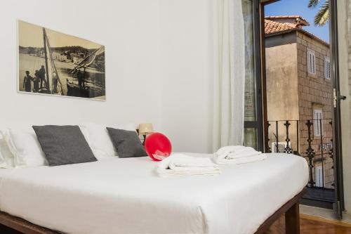 a white bed in a room with a window at San Teodoro Boutique Hotel in Korčula
