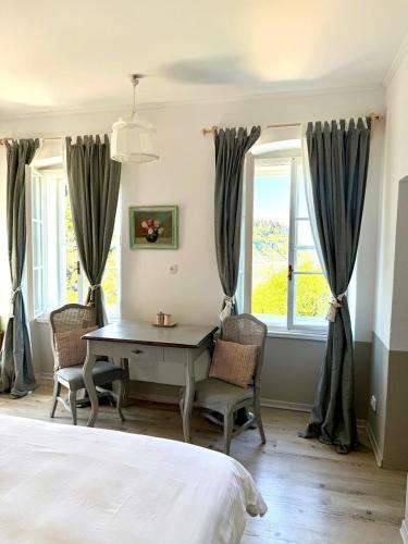 a bedroom with a desk and two windows at Apartments Olive Garden in Piran