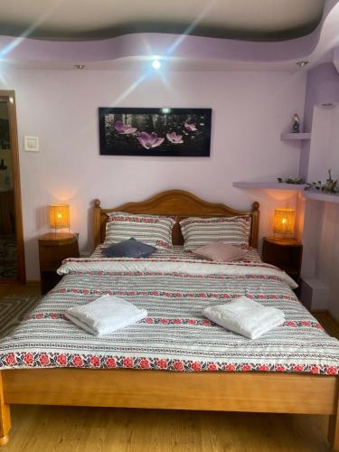 a bedroom with a large bed with two pillows on it at Central Home in Piatra Neamţ