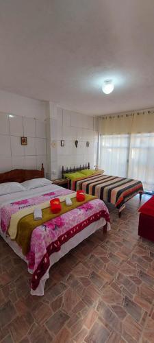 a bedroom with two beds in a room at Contos de Alice Quartos in Tiradentes