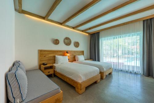 a bedroom with two beds and a window at The Pearl Ölüdeniz in Oludeniz