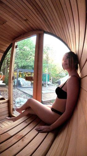 a woman in a black panties sitting in a window at Bubble Glamping Sicily in Trecastagni