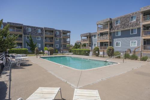 a swimming pool in the courtyard of a apartment complex at 4104 - Sever's Hideaway in Duck