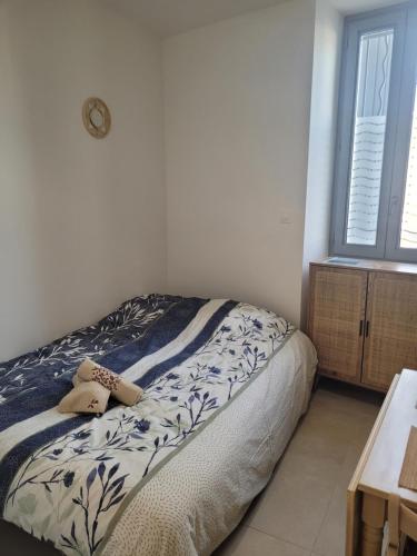 a bedroom with a bed in a room with a window at Le cocon de Suze in Suze-la-Rousse