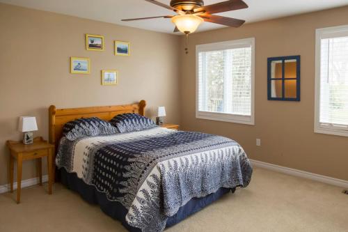 a bedroom with a bed and a ceiling fan at Whispering Swan Bay Haven in Trenton
