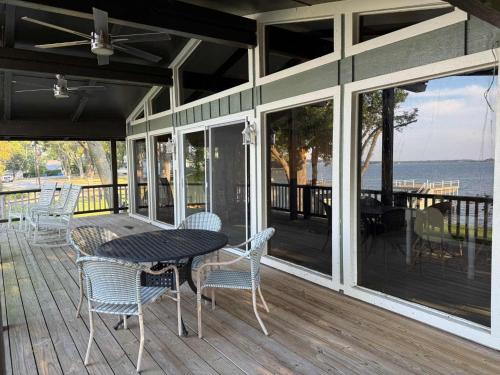 a patio with a table and chairs on a porch at Lakeview Lookout in Tool