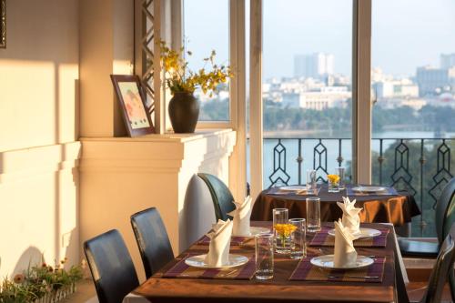 a dining room with a table and chairs and a window at Lakeside Palace Hotel in Hanoi