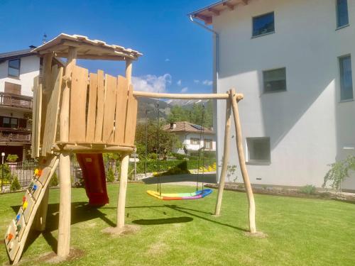a playground in a yard with a swing at Sognatrentino in Cialini