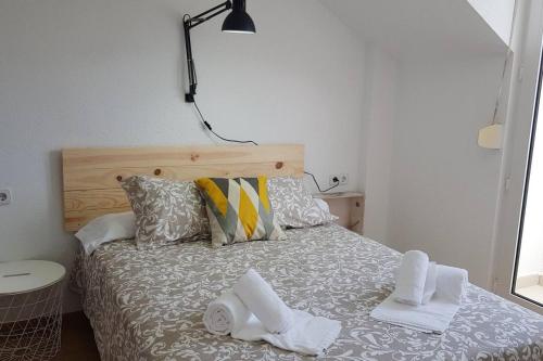 a bedroom with a bed with towels on it at La Arena 4410 in Isla