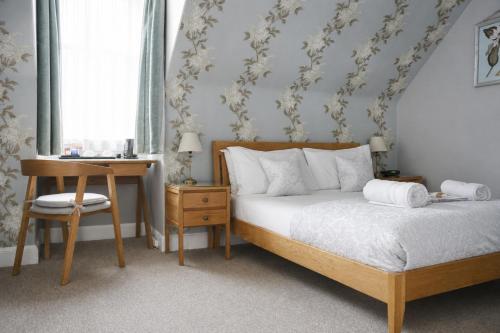 a bedroom with a bed and a table and a desk at Gladstone House in Edinburgh