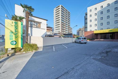 an empty street with a car parked in a parking lot at Hotel Select Inn Utsunomiya in Utsunomiya