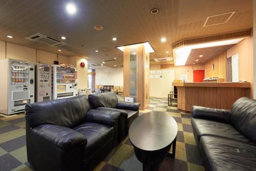 a lobby with leather couches and a table in a store at Hotel Select Inn Utsunomiya in Utsunomiya