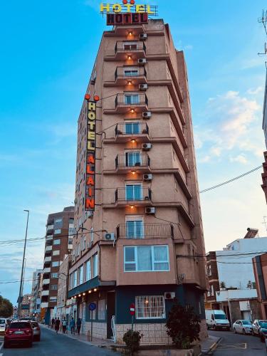 a tall building with a sign on top of it at Hotel Alain by Dynamic Hotels in Silla