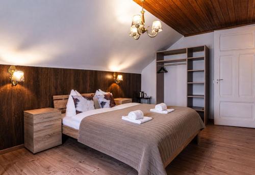 a bedroom with a large bed with two towels on it at Hotel Restaurant Jungfrau in Lauterbrunnen