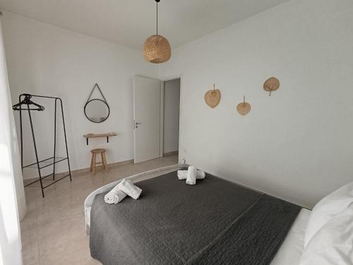 a bedroom with a bed with towels on it at Bougainvillea Apartment Spacious Family Home in Zakynthos Town in Zakynthos