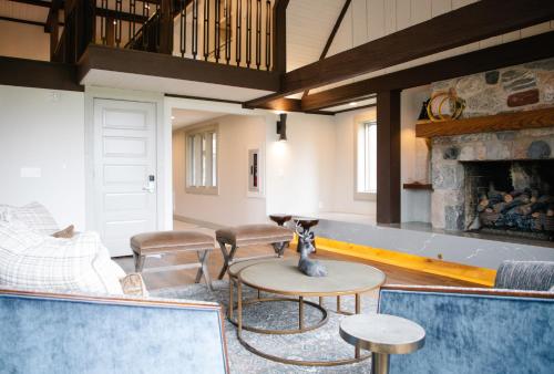 a living room with a couch and a fireplace at The Highlands at Harbor Springs in Harbor Springs