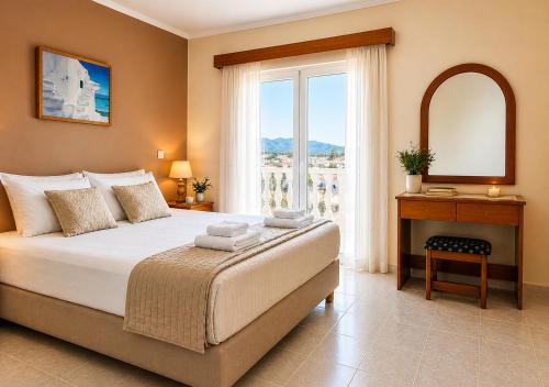 a bedroom with a bed and a table and a window at Villa Joanna in Vasilikos