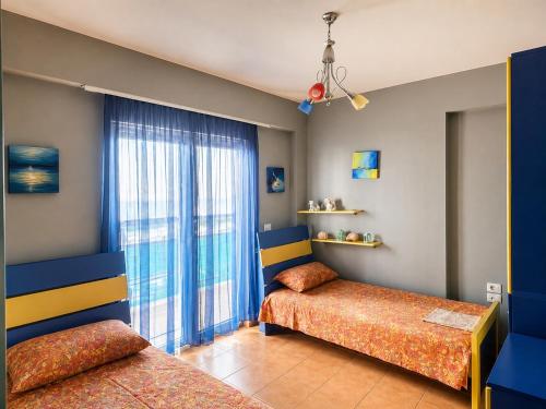 a bedroom with two beds and a window at Sea view apartment 2 in Skataj