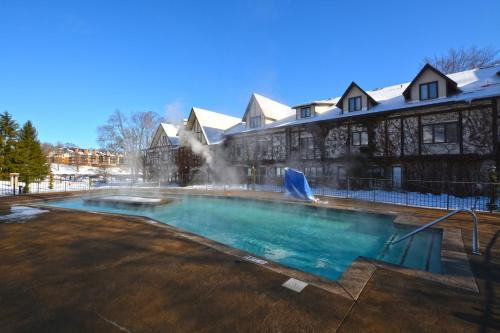 a large swimming pool in front of a building at The Highlands at Harbor Springs in Harbor Springs