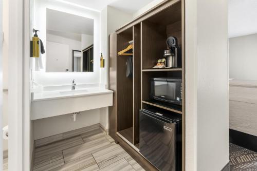 a bathroom with a sink and a tv at Best Western Plus Wausau Tower Inn in Wausau
